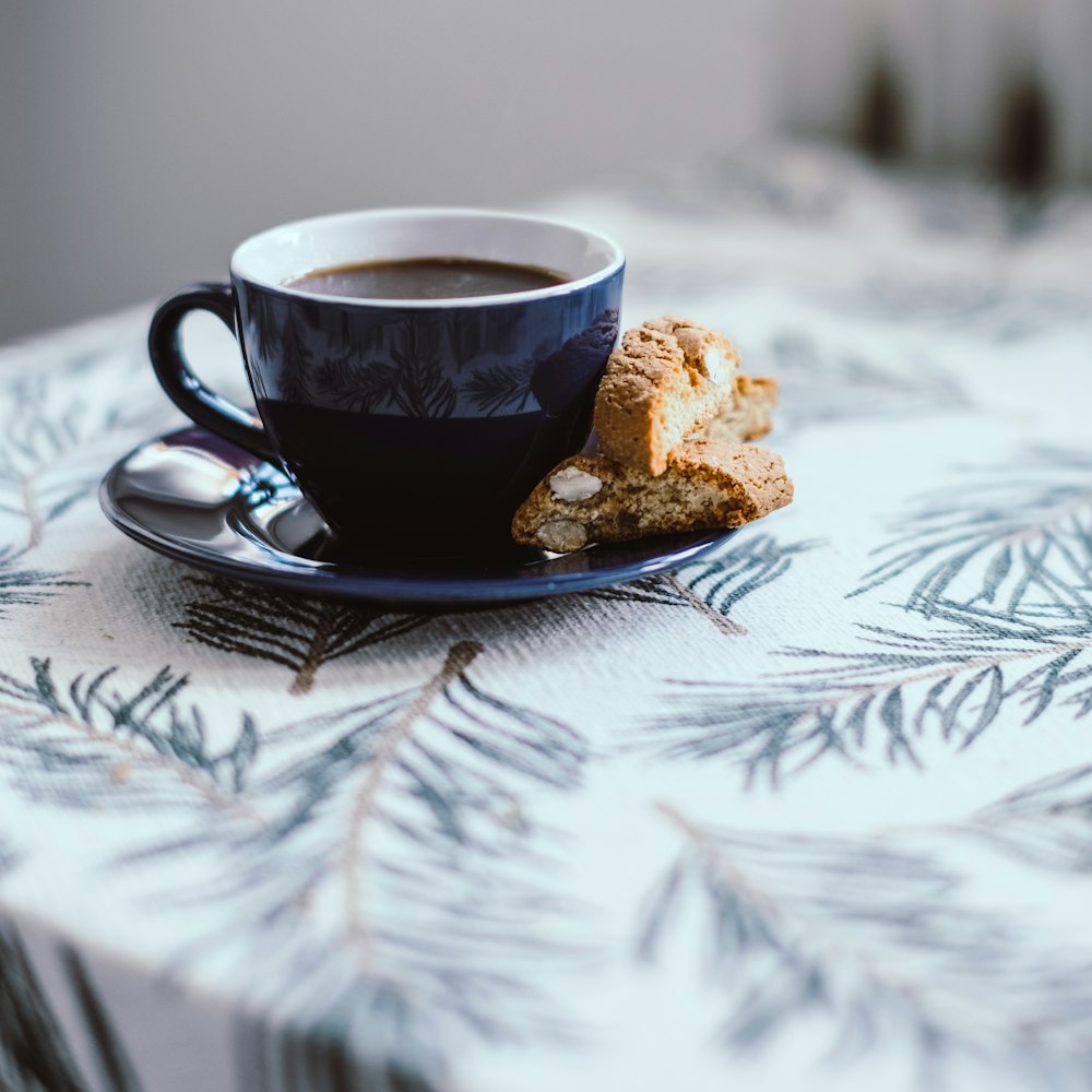 brown and white ceramic cup on black saucer