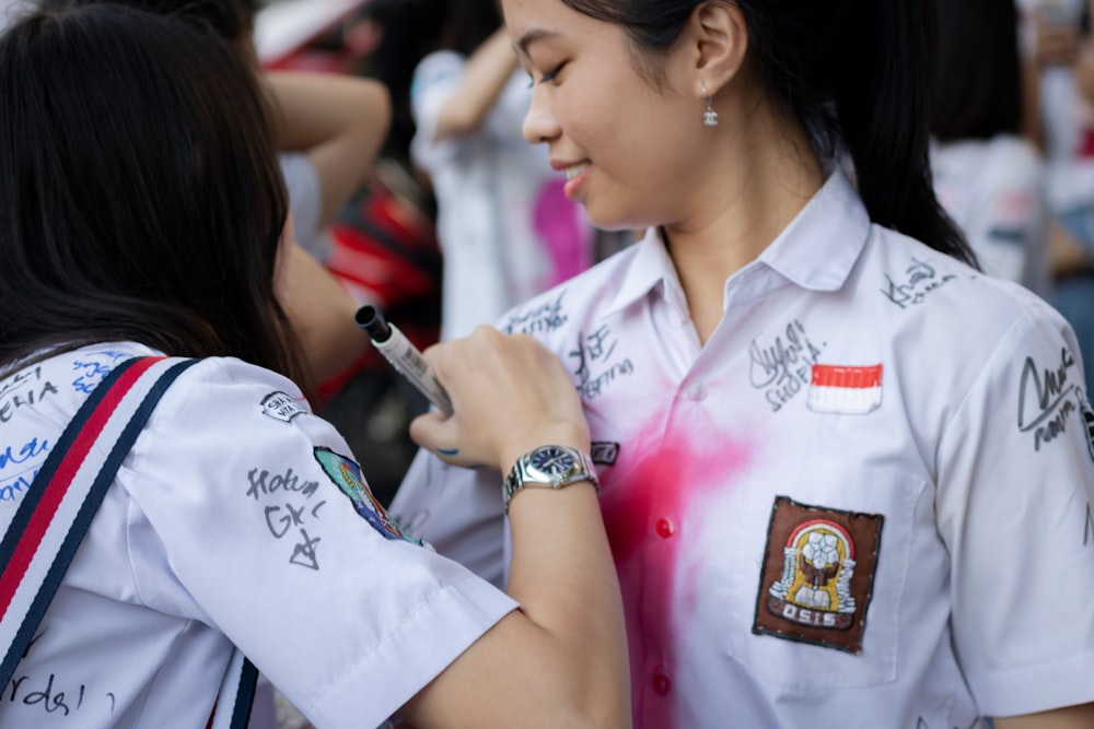 woman in white button up shirt holding pen