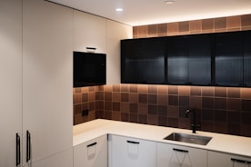 black flat screen tv on white wooden cabinet