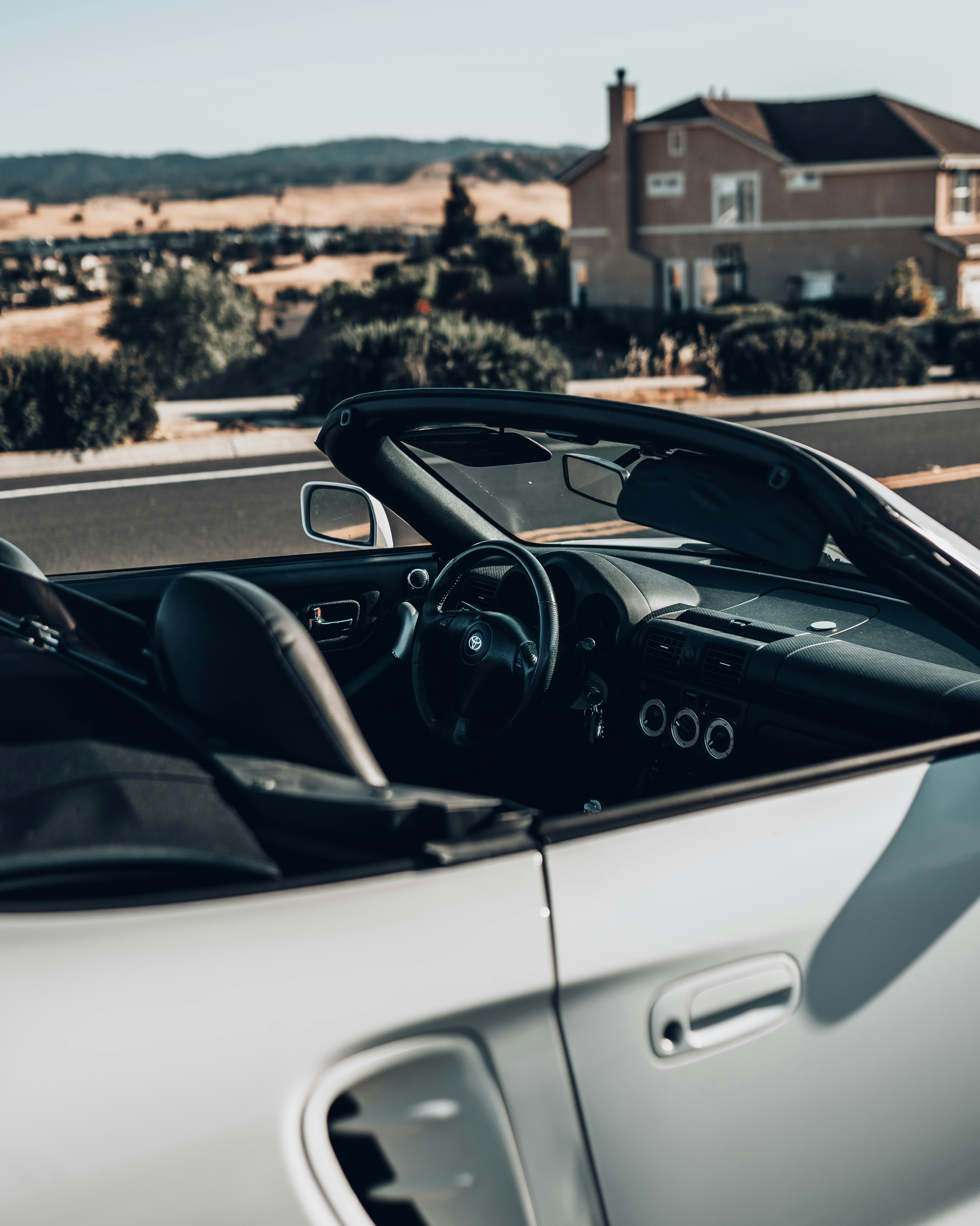 white porsche 911 convertible parked on road during daytime