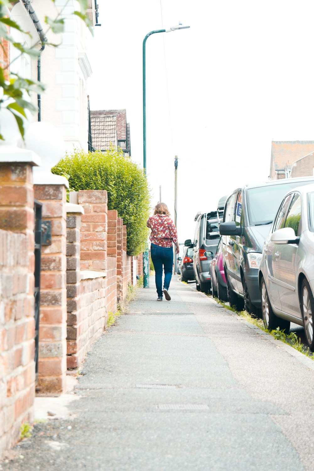 2 women walking on sidewalk during daytime