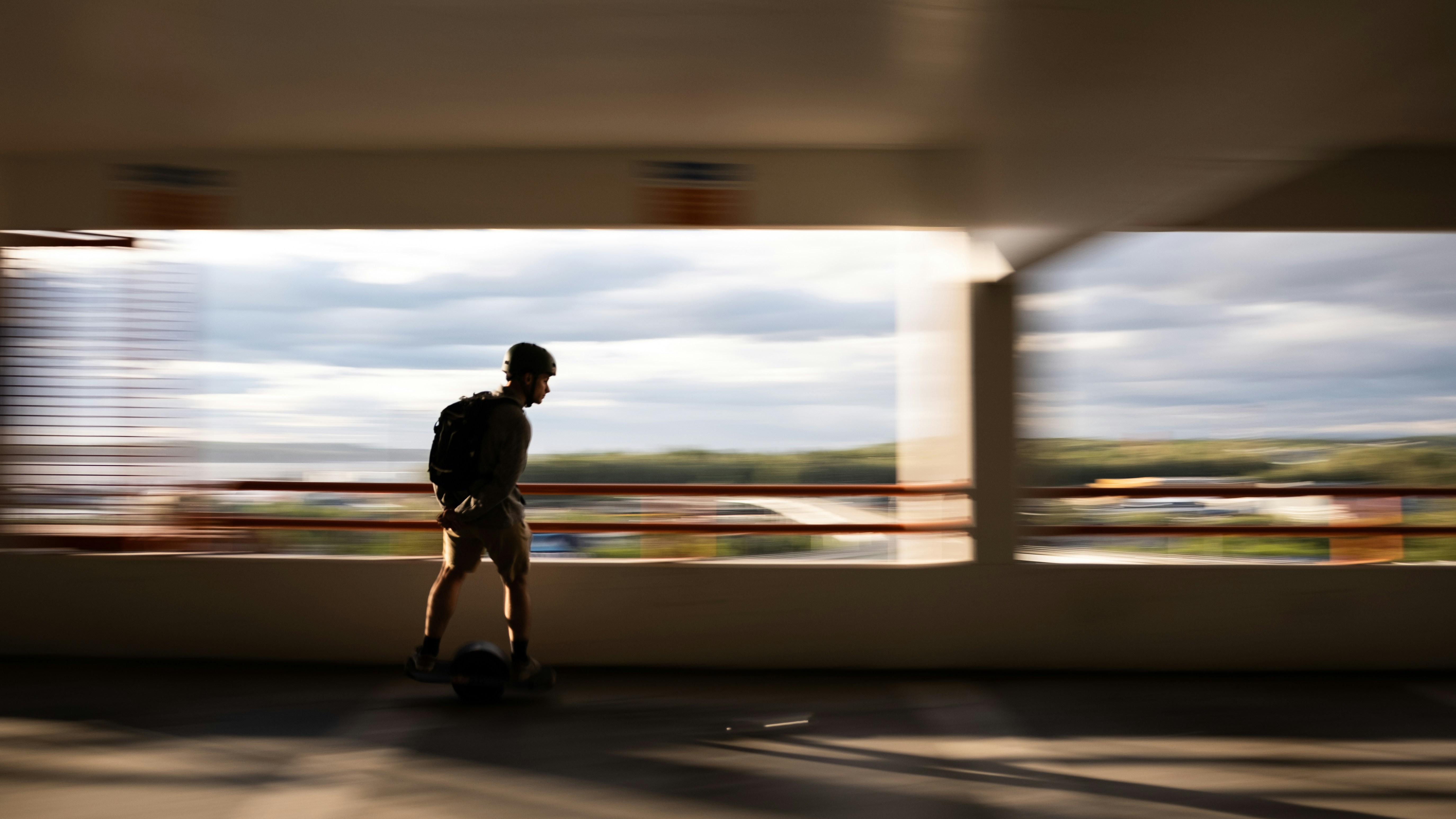 man in black jacket and pants walking on road during daytime