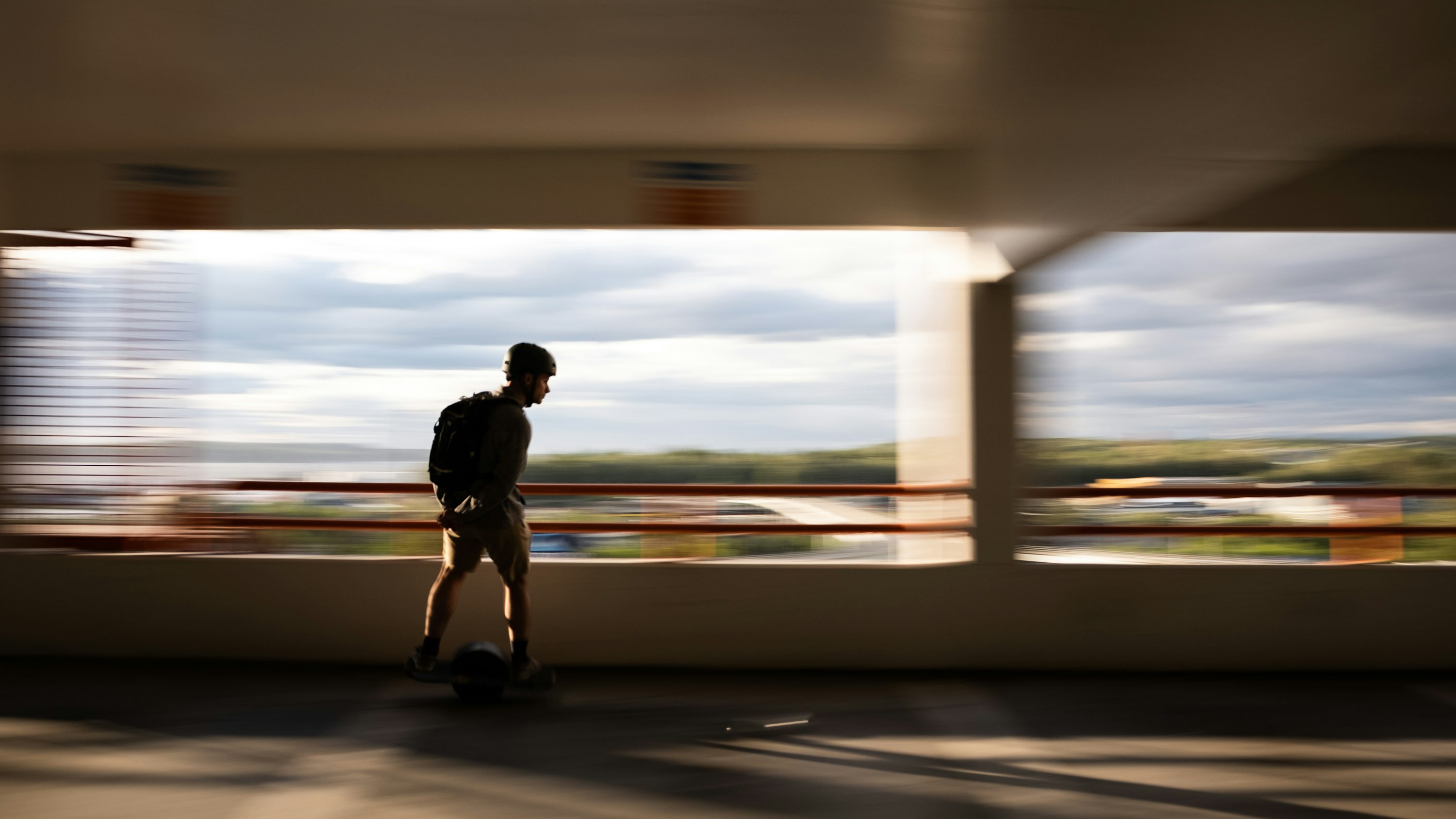 man in black jacket and pants walking on road during daytime