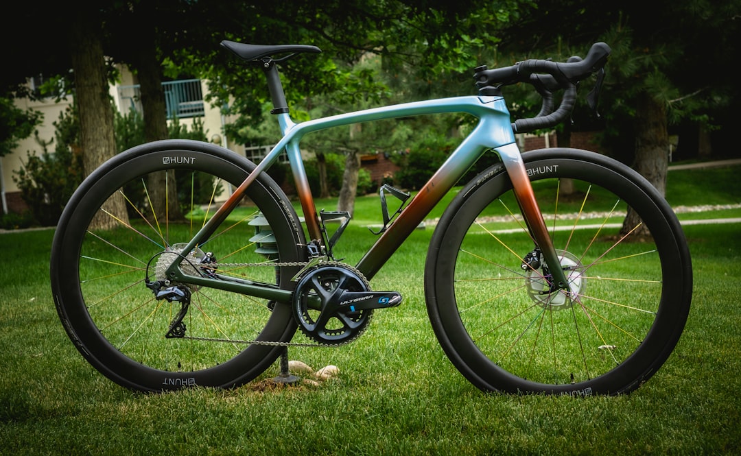 red and black road bike on green grass field