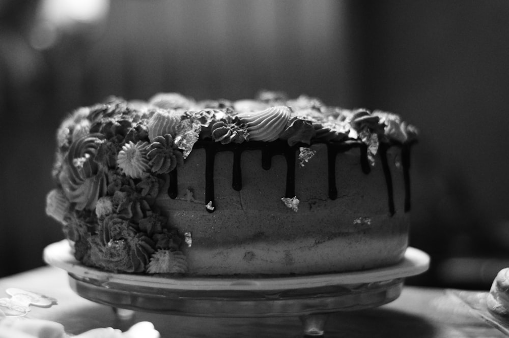 grayscale photo of chocolate cake with flower accent