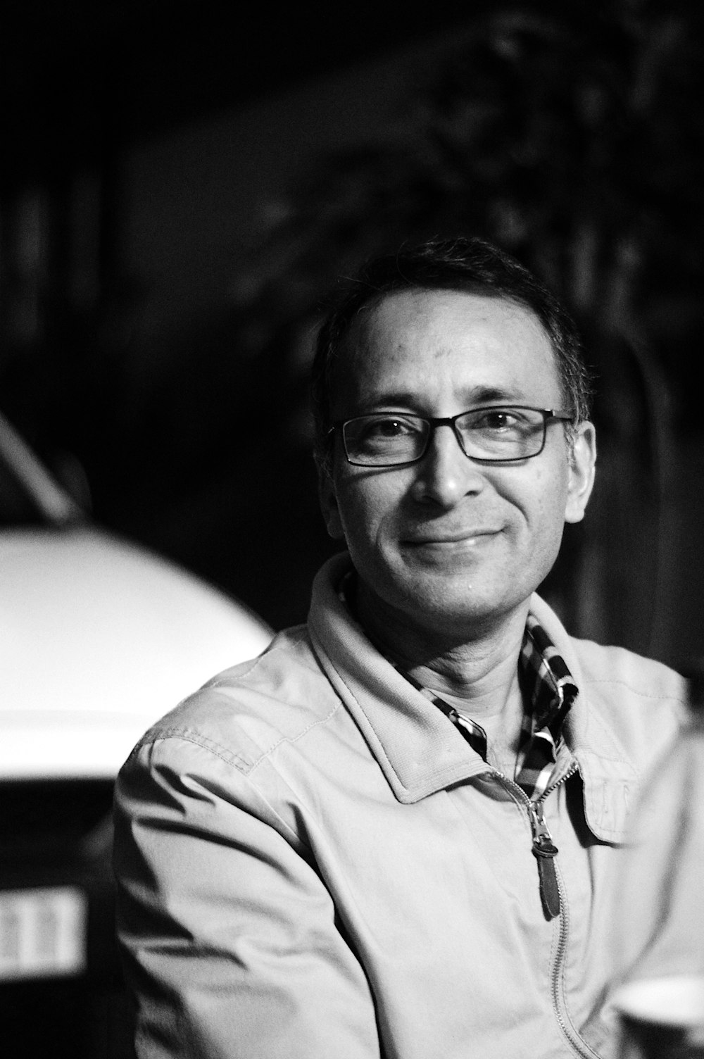 grayscale photo of man wearing eyeglasses and button up shirt