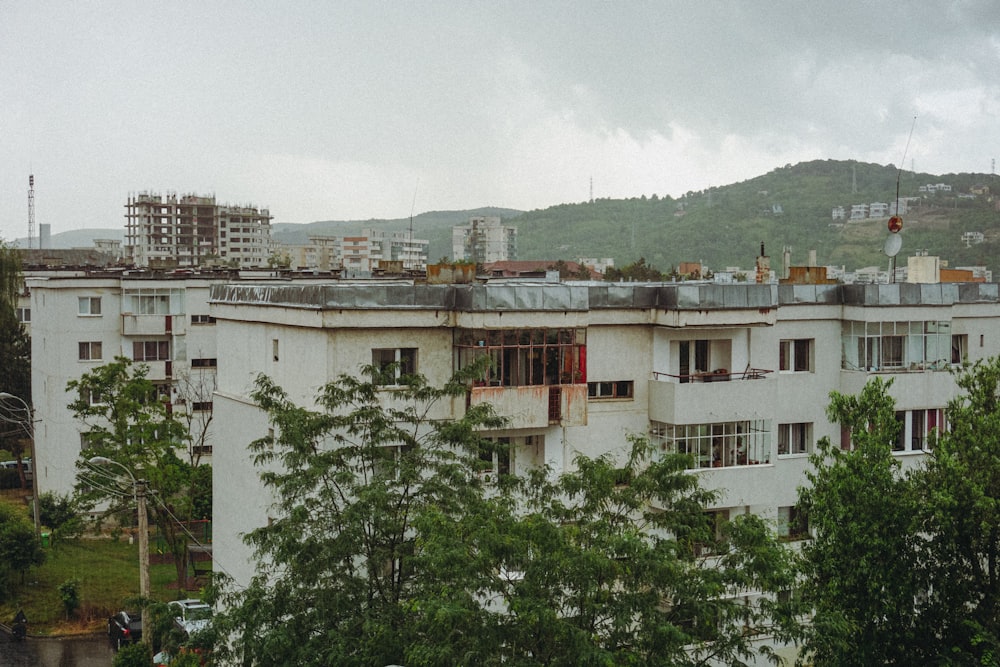 white concrete building near green trees during daytime