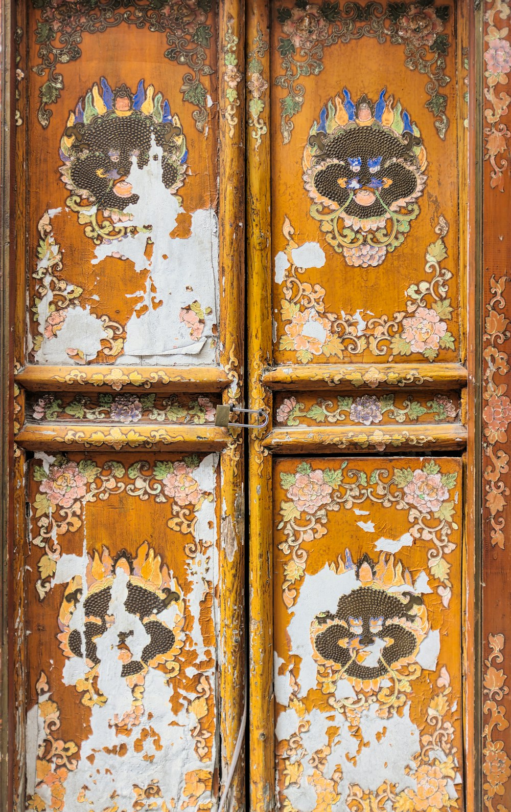 brown wooden door with white and black floral door