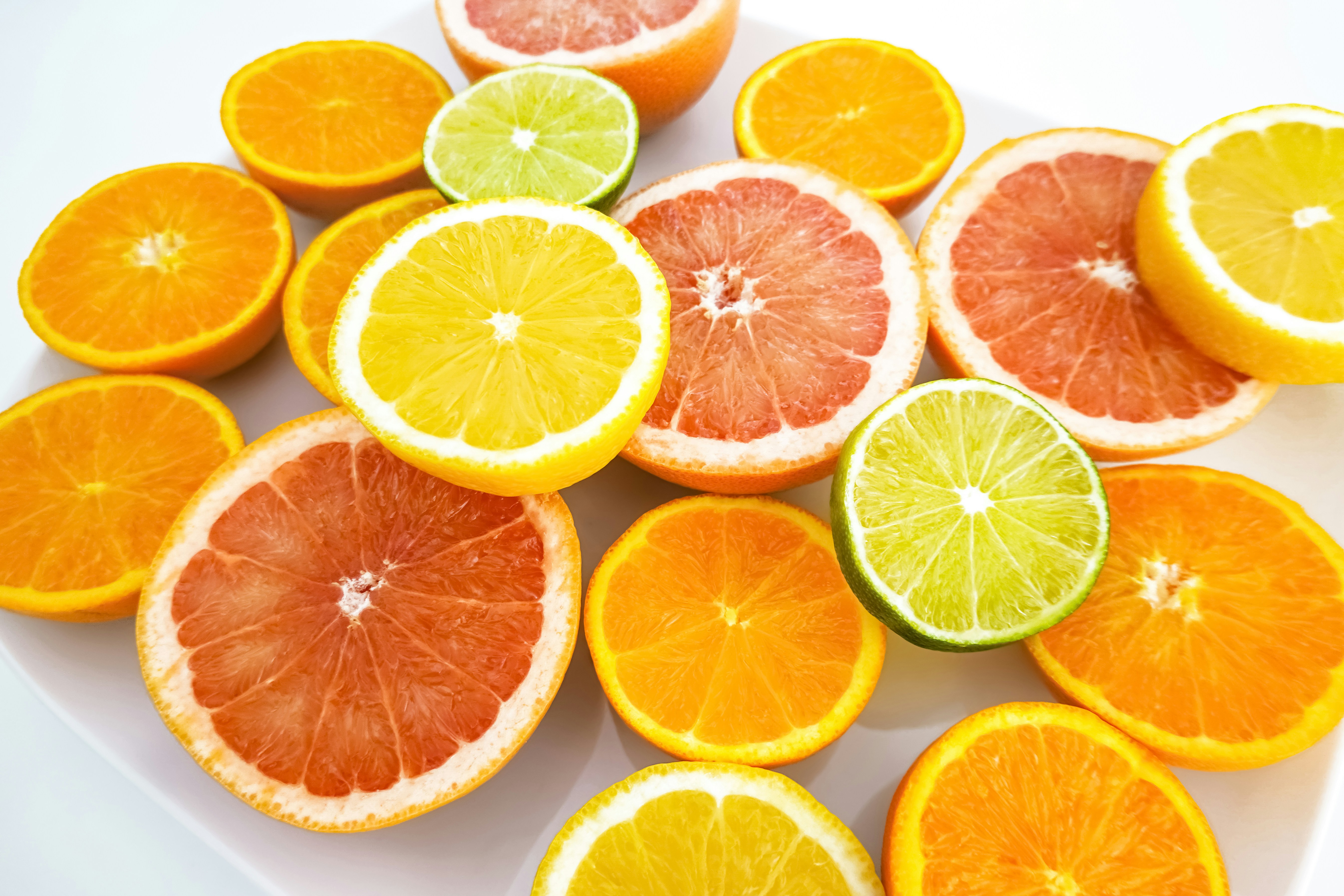 sliced orange fruit on white surface
