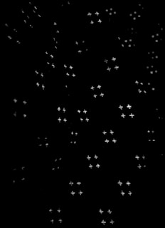 A pattern of small, star-shaped light points scattered randomly across a dark background, creating a night sky effect.