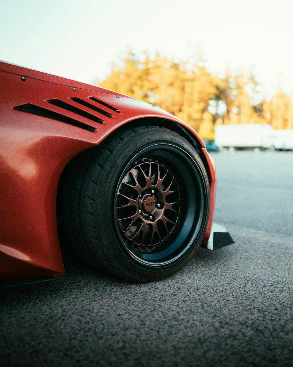 red and black car on road during daytime