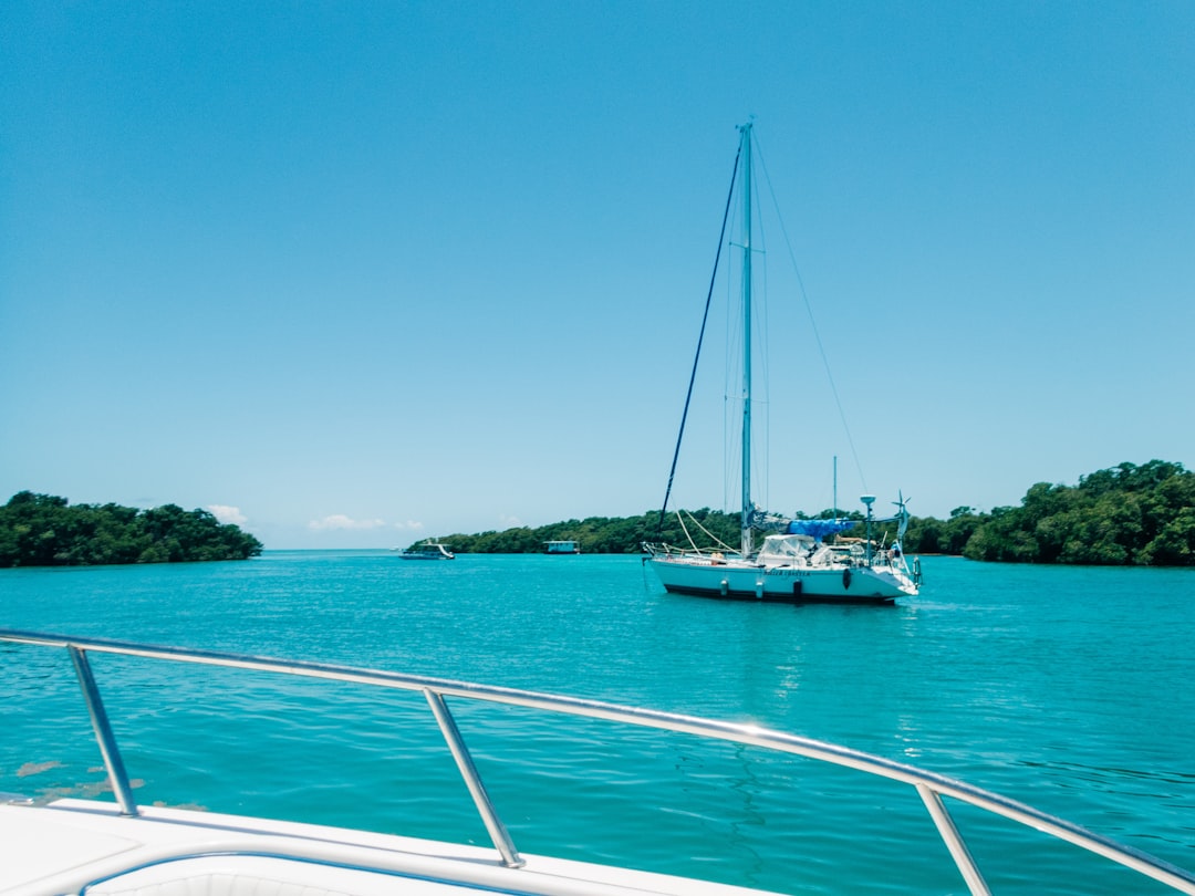 white boat on sea during daytime,