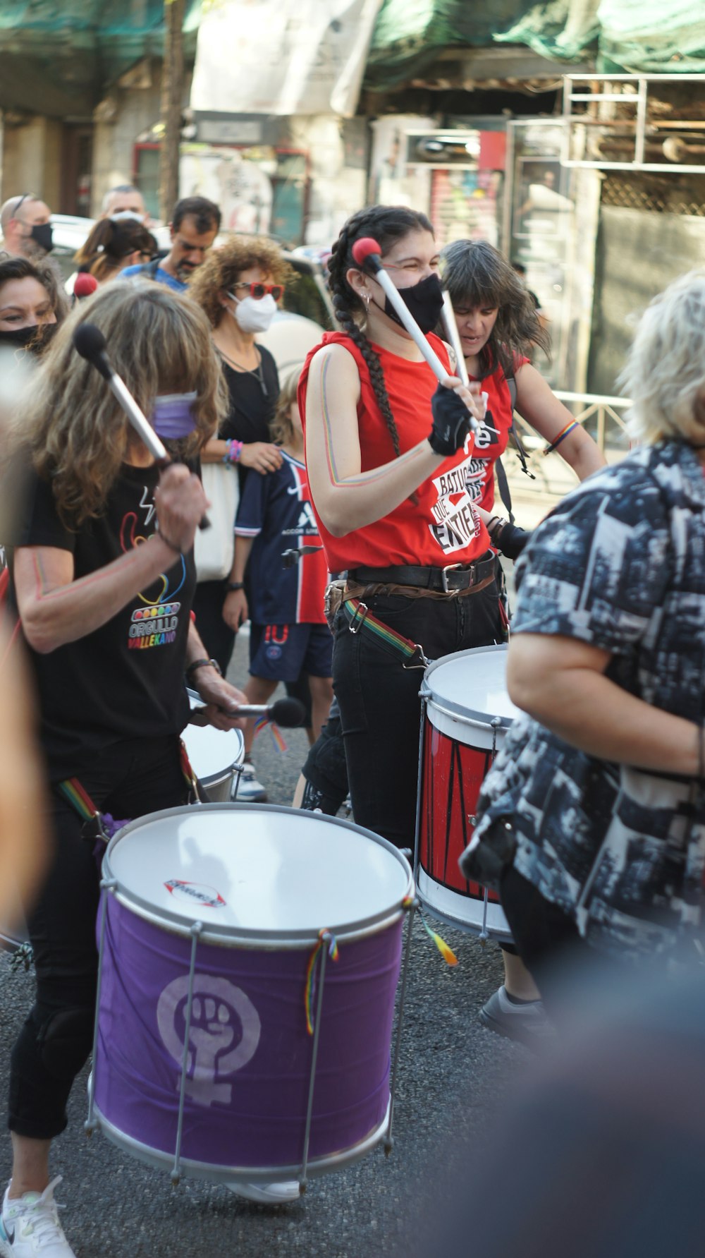 people standing and playing drum during daytime