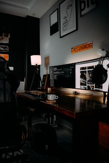 black flat screen computer monitor on brown wooden desk