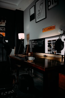 black flat screen computer monitor on brown wooden desk