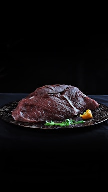 raw meat on black plate