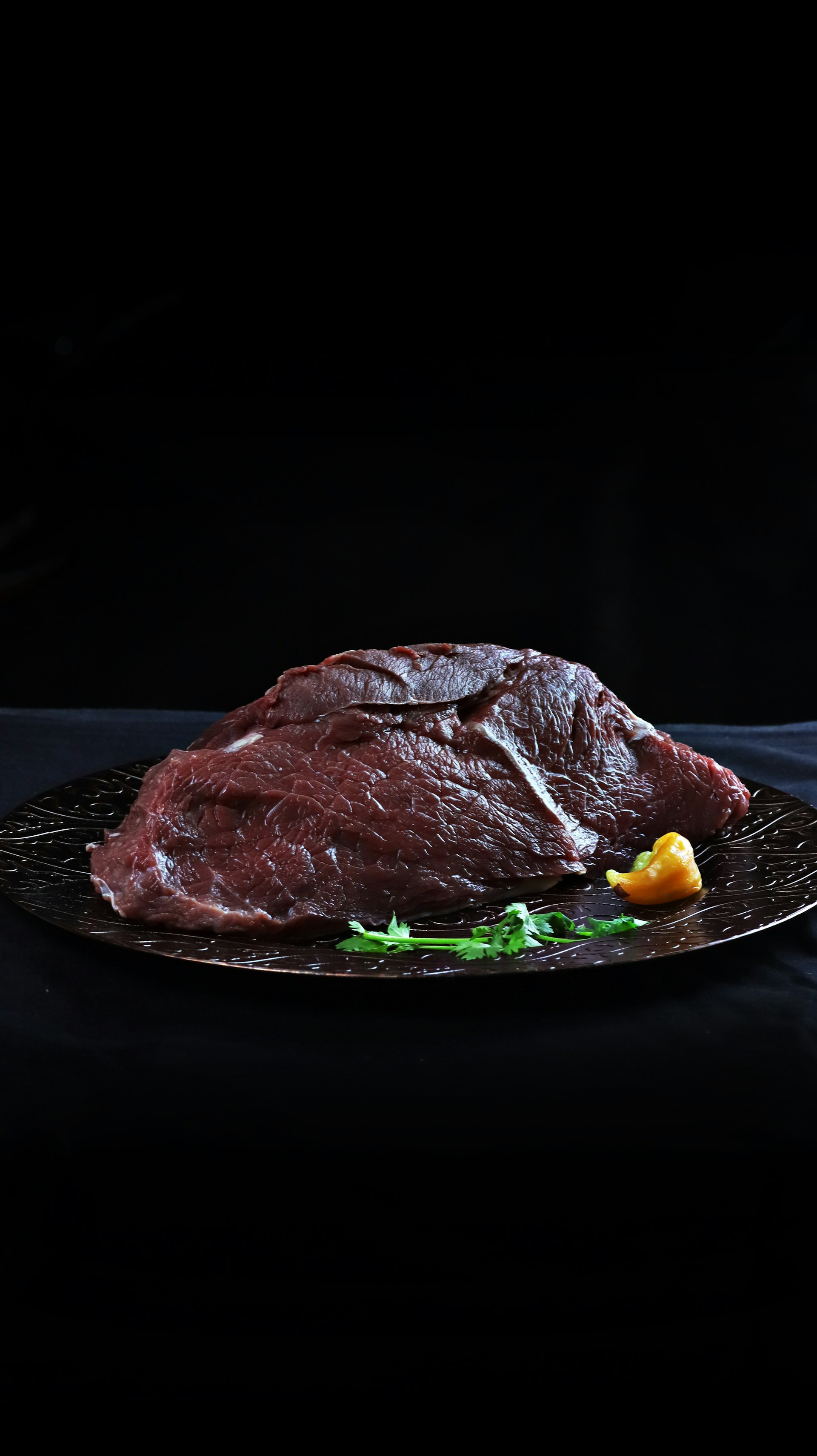 raw meat on black plate