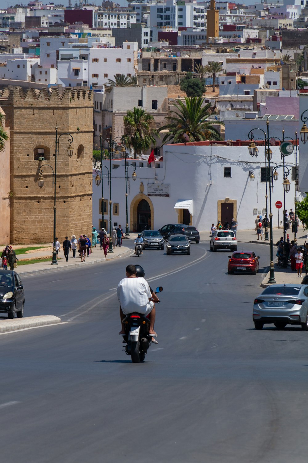 people riding motorcycle on road during daytime