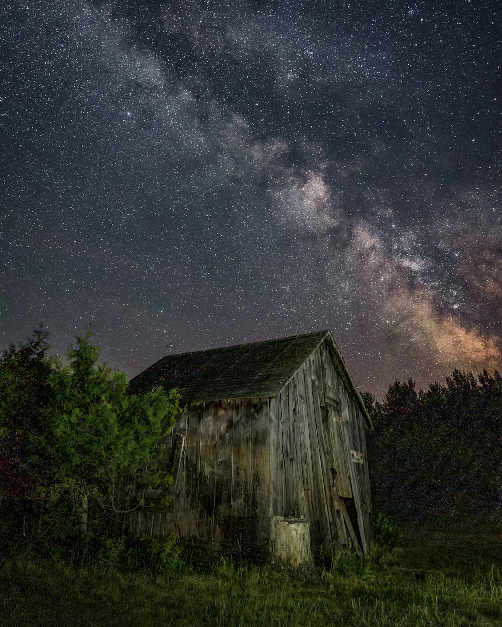 brown wooden house under starry night