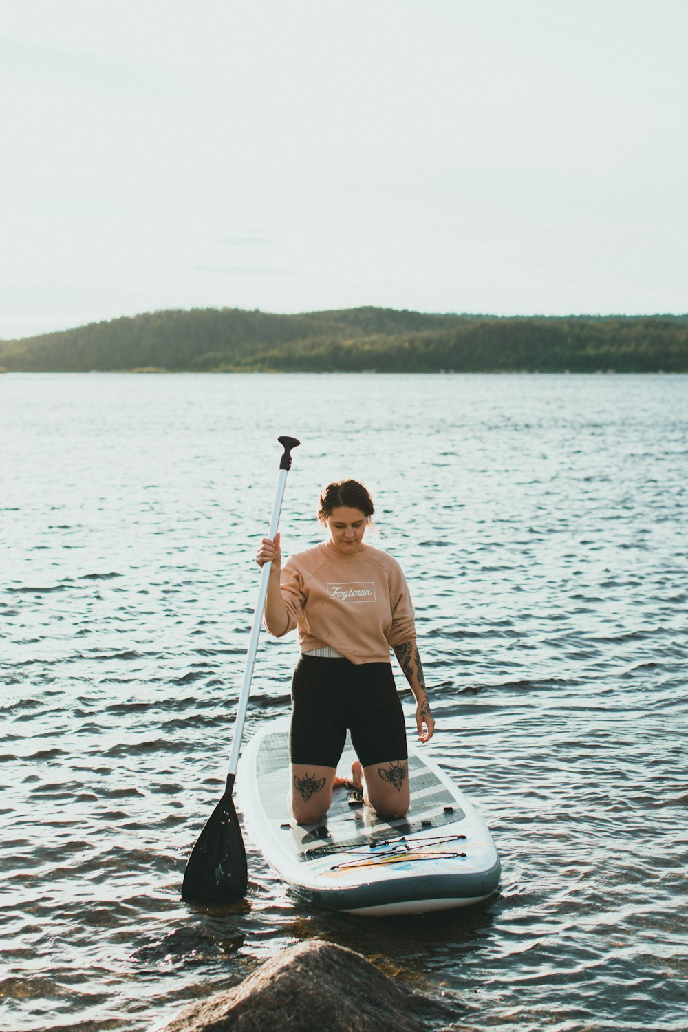 man in brown crew neck t-shirt and black shorts standing on white boat during daytime