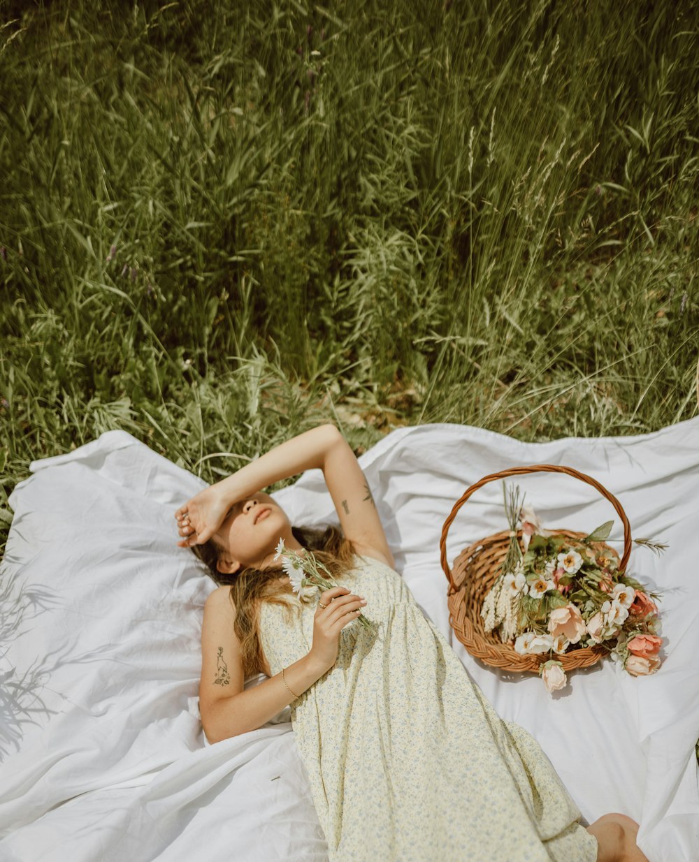 woman in white dress lying on white bed