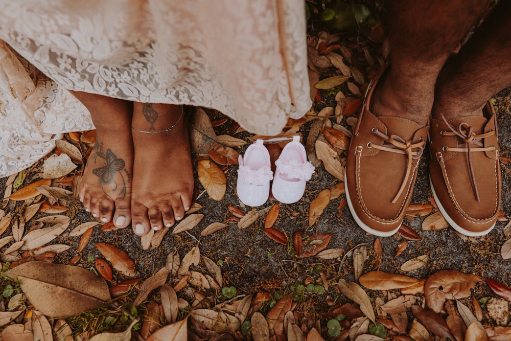 woman in white lace skirt and brown leather shoes standing on dried leaves