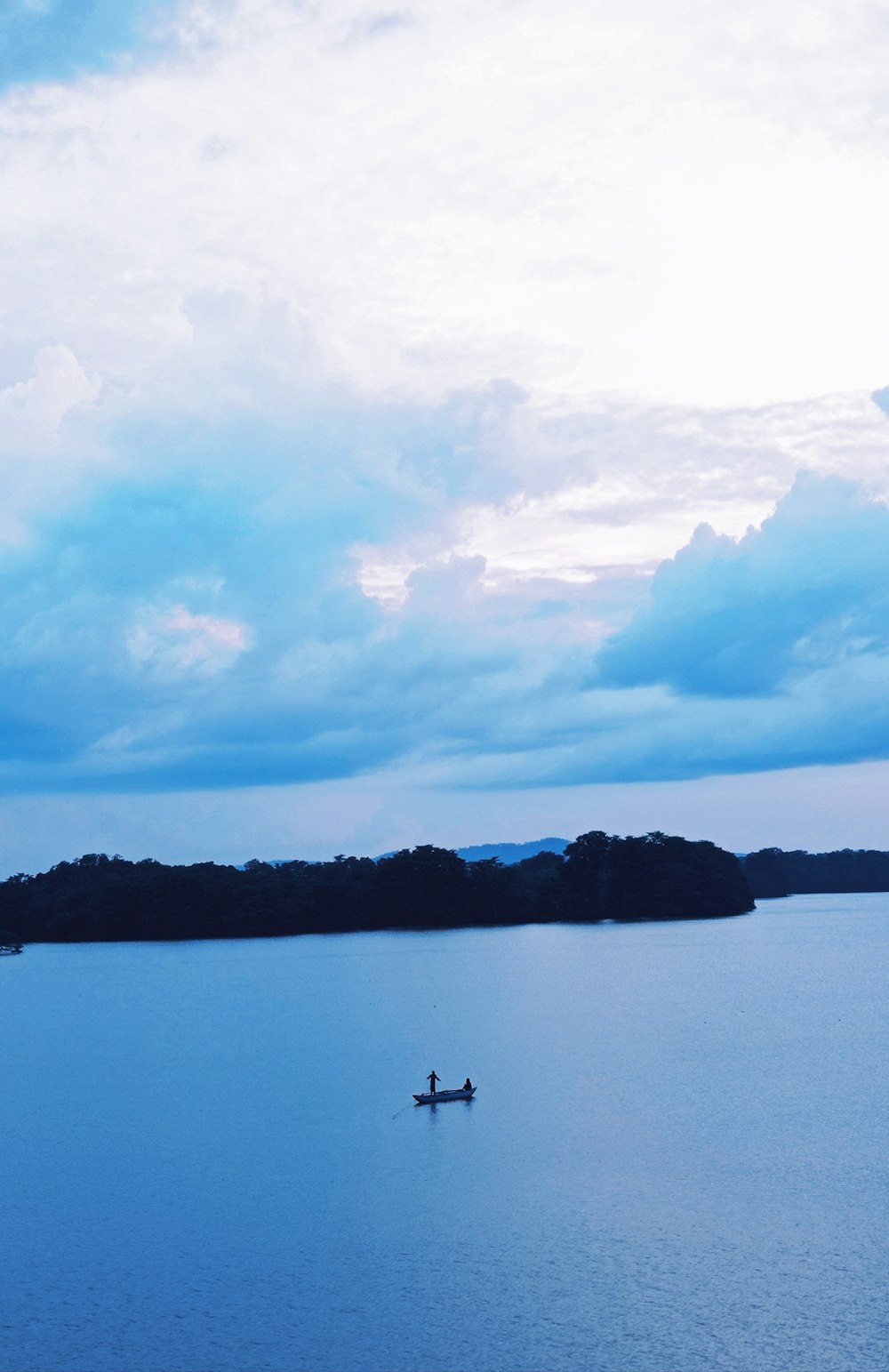 person riding on boat on lake during daytime