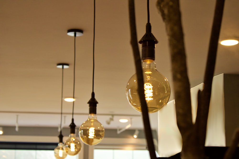 clear glass pendant lamp turned on in room