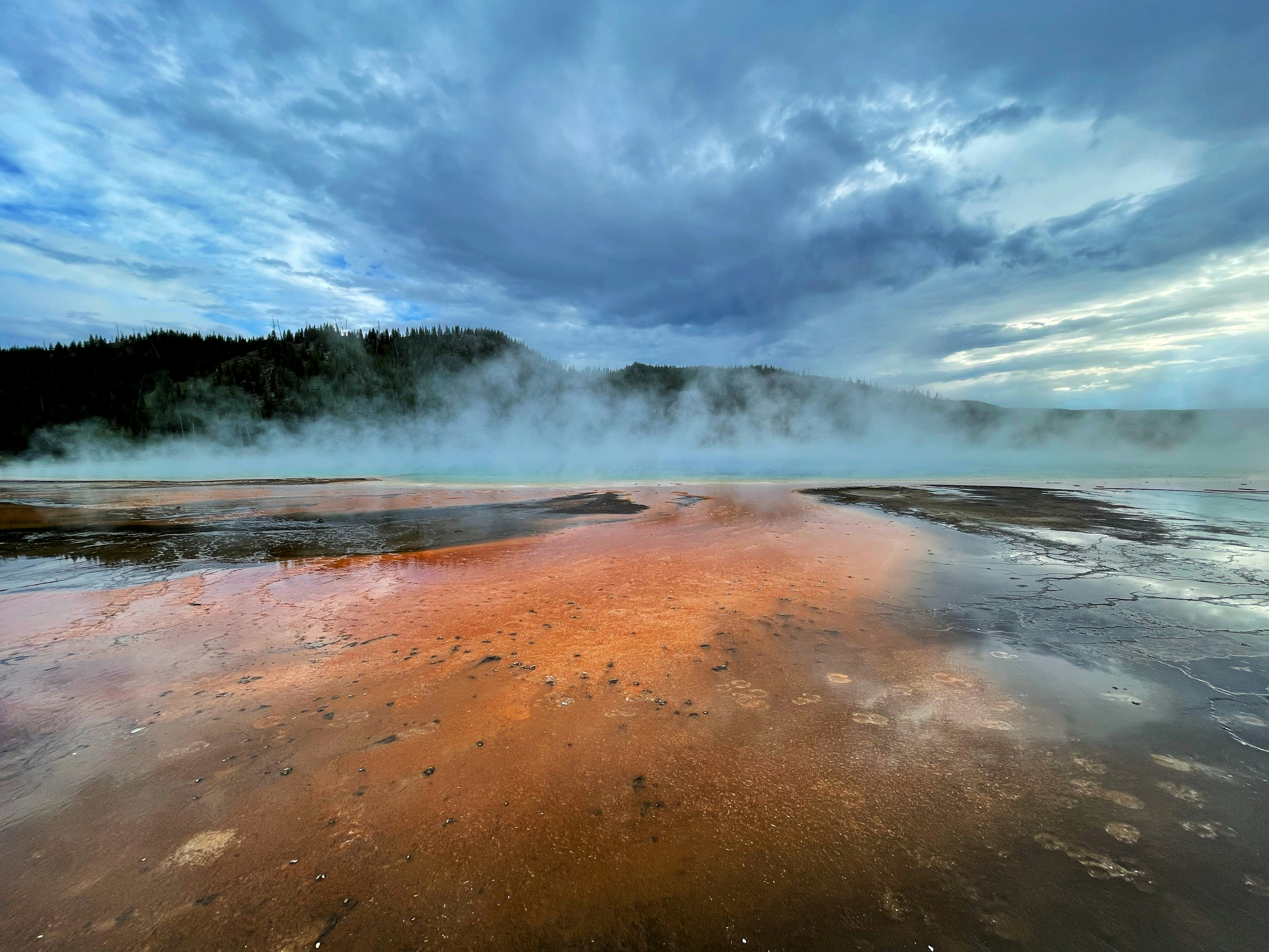brown sand near body of water during daytime, Grand Prismatic Pool, Yellowstone.