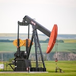 black and orange metal machine on green grass field during daytime