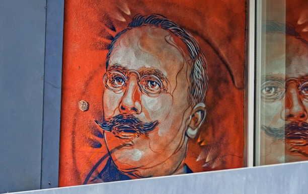 Portrait of Juan Dona working on a vibrant mural in his studio.
