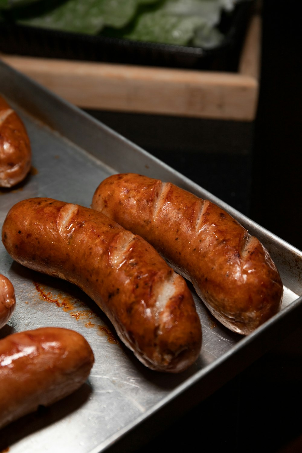 brown sausage on stainless steel tray