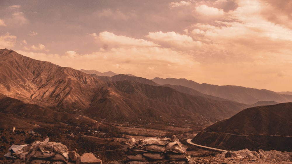 brown mountains under white clouds during daytime