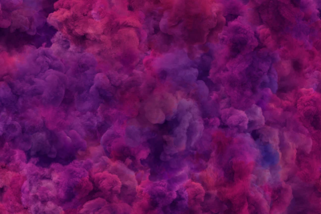 Abstract shot of welding sparks blending into swirling purple and teal tie-dye clouds.