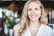 Headshot of Sara L., a happy entrepreneur, with a bright, welcoming background.