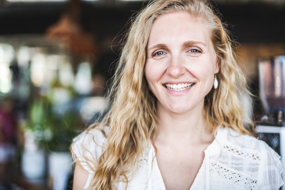 woman in white button up shirt smiling