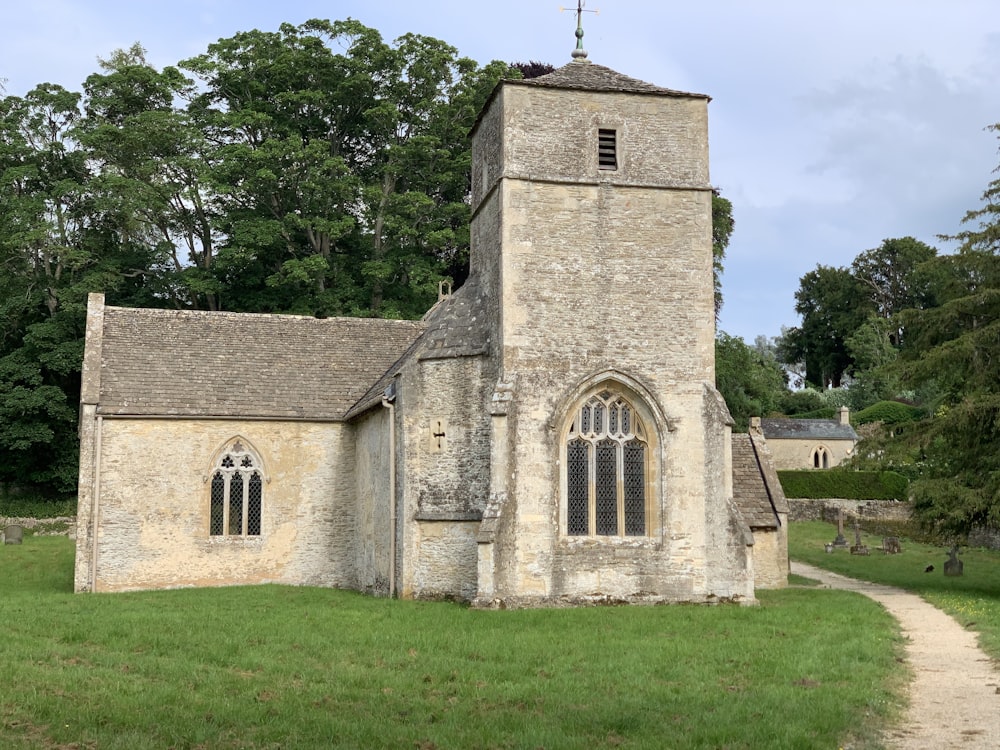 gray concrete church near green trees during daytime