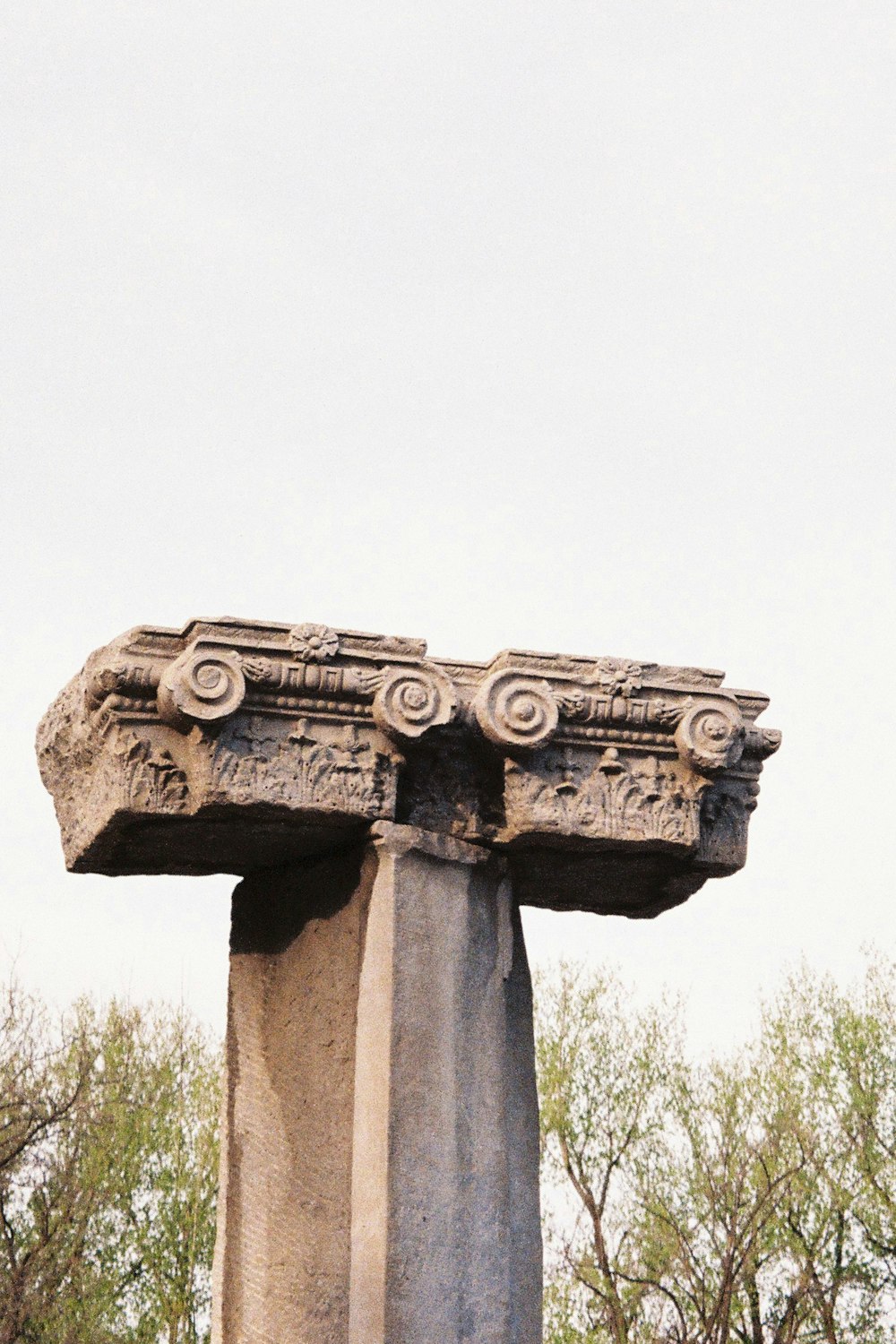 gray concrete statue under white sky during daytime