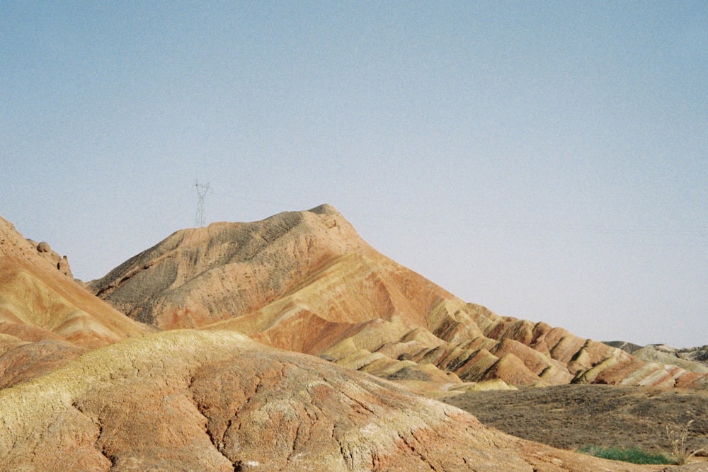 brown rocky mountain under blue sky during daytime