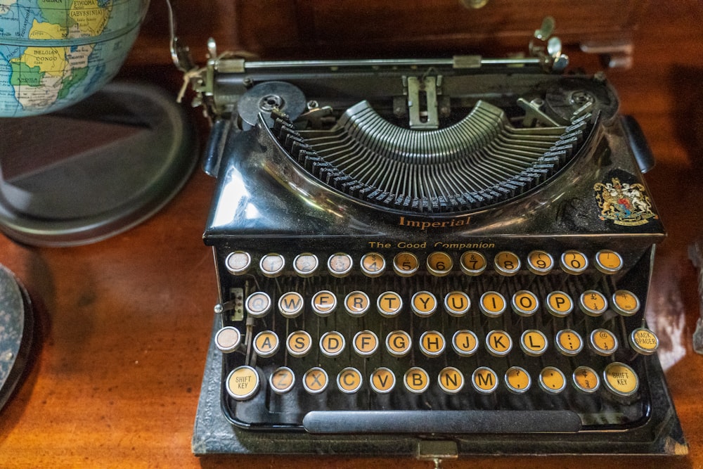 black typewriter on brown wooden table