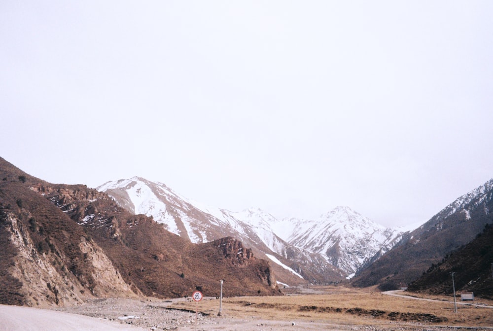 brown and white mountains under white sky during daytime