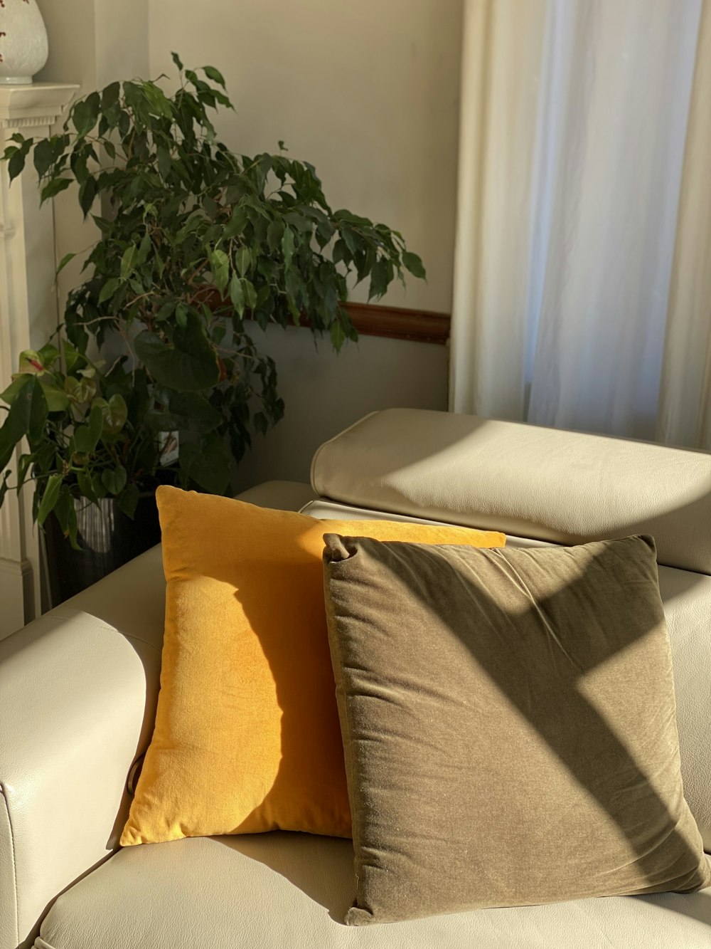 yellow throw pillow on white couch