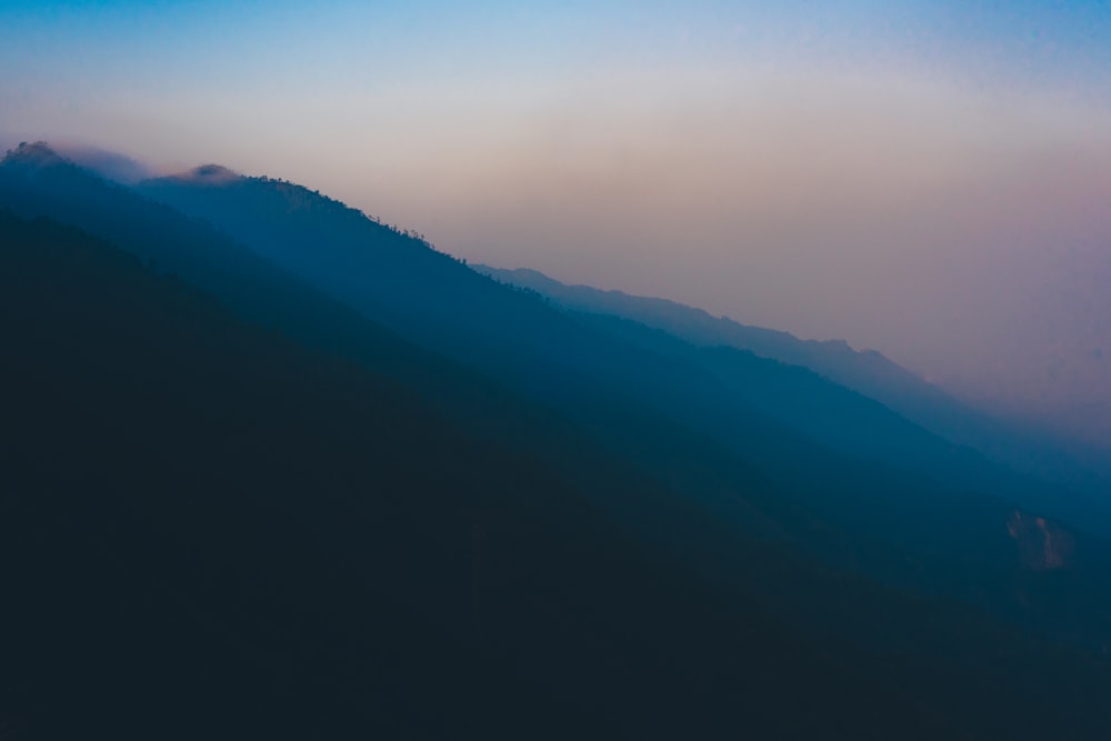 mountains covered with fog during daytime