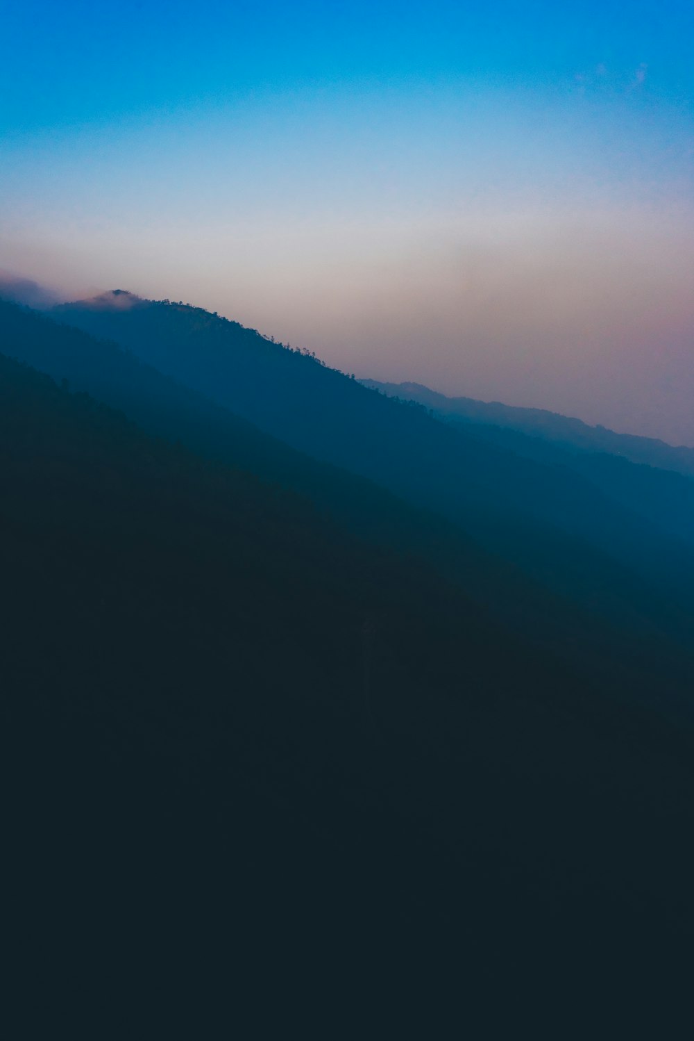 mountains under white clouds during daytime