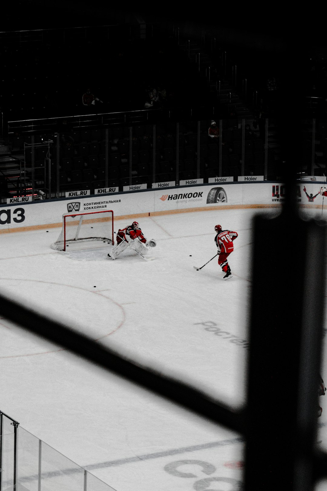 people playing ice hockey on ice field during daytime