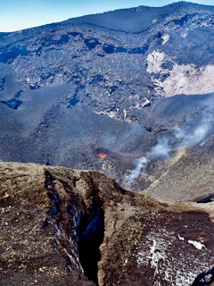 A vibrant 3D representation of a volcanic crater with detailed rock textures.