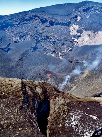 A vibrant 3D representation of a volcanic crater with detailed rock textures.