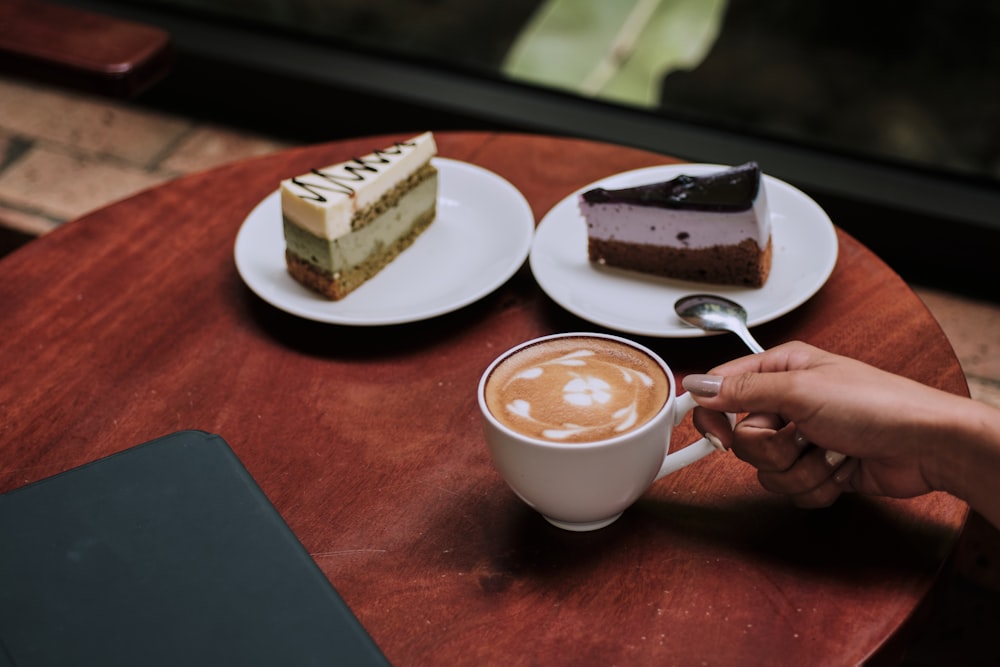 person holding white ceramic mug with coffee