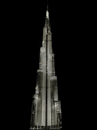 A sleek 3D rendering of a modern building glowing softly against a dark background, highlighting intricate architectural details.