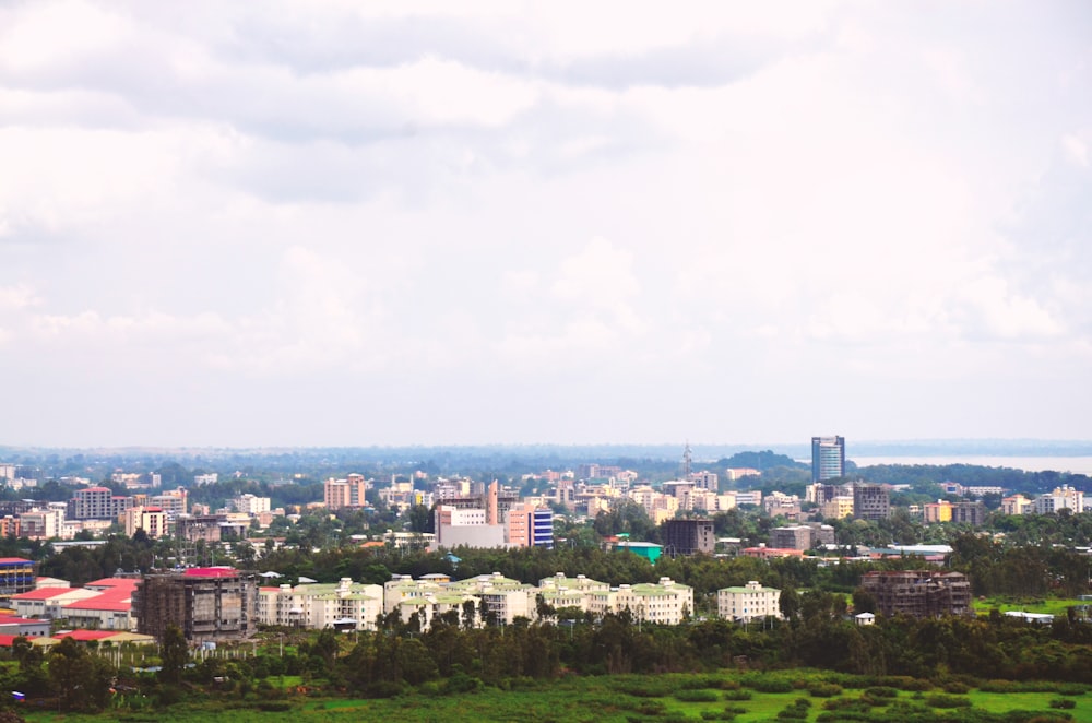 city with high rise buildings under white sky during daytime